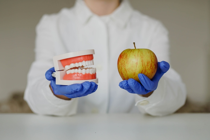 Dentist showing foods that can damage teeth and harm a healthy smile in St. Louis, MO.